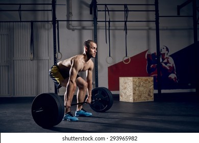 Young Shirtless Man Doing Deadlift Exercise At Gym