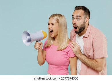 Young Shocked Couple Two Friends Family Man Woman In Casual Clothes Hold Scream In Megaphone Announces Discounts Sale Hurry Up Together Isolated On Pastel Plain Light Blue Color Background Studio.