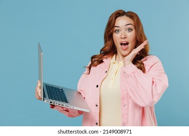 Young Shocked Freelancer Redhead Chubby Overweight Woman 30s In Pink Shirt Casual Clothes Using Laptop Pc Computer Holding Face Isolated On Pastel Blue Color Background Studio People Lifestyle Concept
