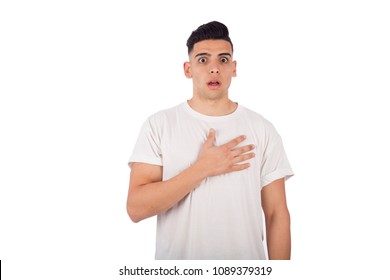 Young Shocked Man Putting His Hand On His Heart, Isolated On A White Background.