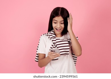 Young shocked teenage girl with bag on pink background in studio. - Shutterstock ID 2394599561