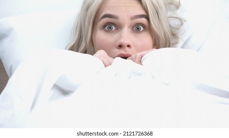 Young Shocked Woman Covering With White Blanket In Bed