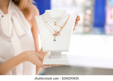 Young Shop Assistant With Beautiful Jewelry In Store