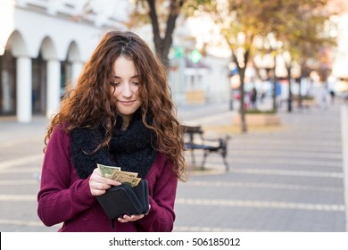 Young Shopper Woman Taking Out Money From Wallet On Street