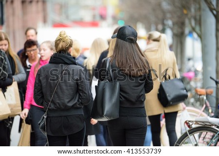 Young shopping women on crowded street