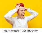 young short-haired angry girl in stress screams on a yellow isolated background, unhappy hipster woman with piercing suffers from problems and depression