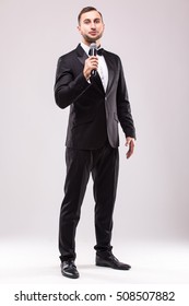 Young Showman presenter with microphone against white background.Showman concept.