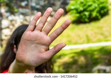 Young Shy Girl Hand Protect Herself From The Camera