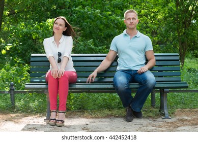 Young Shy Man Flirting With Woman In Park