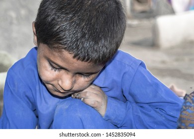 A Young Sick Child Suffering From Cancer And Looks Very Sad