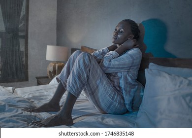 Young Sick And Depressed Black African American Woman Sitting On Bed At Home Unhappy And Sleepless At Night Feeling Overwhelmed Suffering Depression And Anxiety Problem