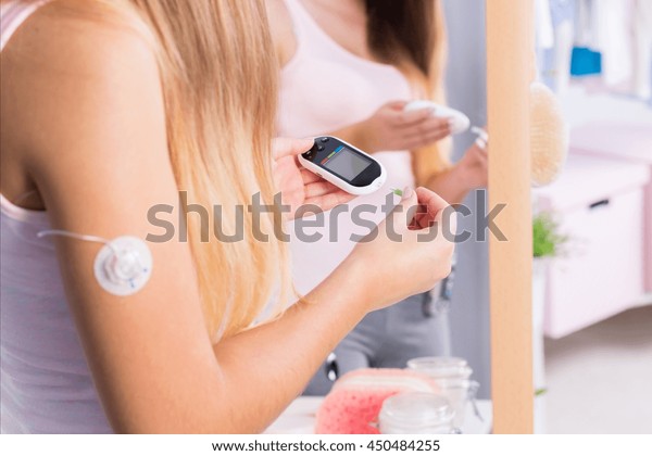 Young sick\
girl with insulin pump injection on\
arm