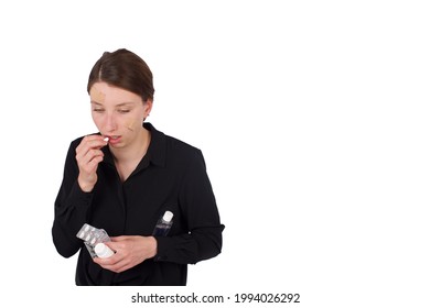 Young Sick, Injured Woman Taking Medicine. Ouch! Bandaid On Face. Prescribed Pain Killers. White Background Isolated.