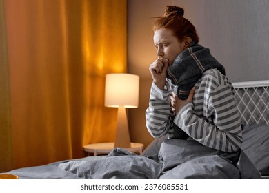 Young sick pale woman sitting in bed at home, close up portrait. side view. bad day. patient suffer from cough. - Powered by Shutterstock