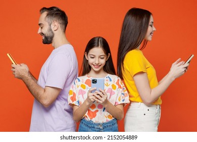 Young Side View Fun Parents Mom Dad With Child Kid Daughter Teen Girl In Basic T-shirts Hold In Hand Use Mobile Cell Phone Isolated On Yellow Background Studio Family Day Parenthood Childhood Concept