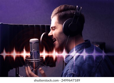 Young singer with microphone recording song in studio. Audio waveform near him - Powered by Shutterstock