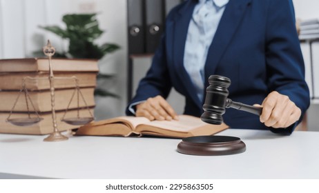 Young single female lawyer asian people in formal suit real estate working law book and contract documents, Arguments for Defense Strategy. Fight for Freedom. Supporting Evidence. - Shutterstock ID 2295863505