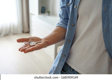 Young Single Man Tenant Renter First Time Home Owner Holding Key To New Apartment On Hand. Male House Buyer Customer Moving Into Own Flat, Buy Real Estate Mortgage Investment Purchase Concept. Closeup