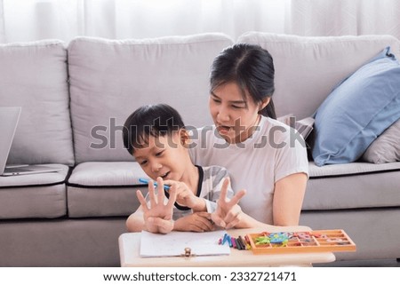 Young single mother teach little preschool age son to count explain math basics, doing homework together on holidays. Smart child boy prepares for school learn mathematics. education concept.