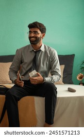 Young sitting on bed while getting ready for office