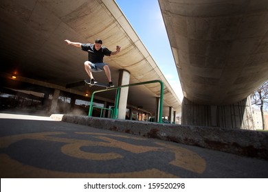 Young Skateboarder doing a Crooked Grind trick on a Rail - Powered by Shutterstock