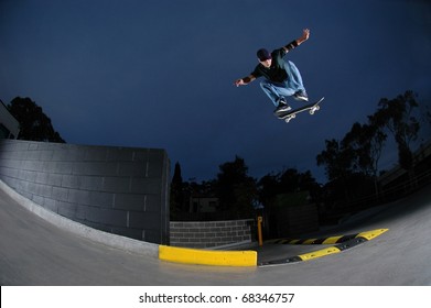 Young Skateboarder Jumping Off A Ledge