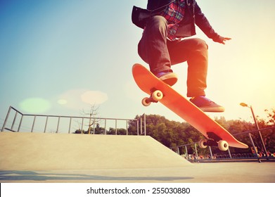 Young skateboarder legs skateboarding at skatepark - Powered by Shutterstock