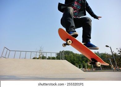 young skateboarder legs skateboarding at skatepark - Powered by Shutterstock