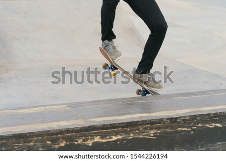 Similar – Image, Stock Photo Skateboarder performing a trick on a rail at a skatepark.