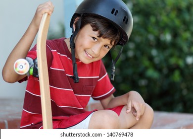 Young Skateboarder Rests Wearing Helmet And Red Tee-shirt - Shallow Depth Of Field