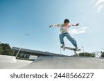 A young skater boy confidently rides his skateboard up the side of a ramp in an outdoor skate park on a sunny summer day.