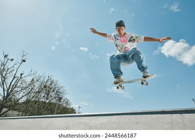 A young skater boy defies gravity, soaring through the air on his skateboard in a sunny skate park. - Powered by Shutterstock