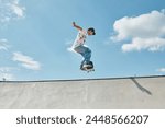 A young skater boy fearlessly riding a skateboard up the side of a ramp in a vibrant outdoor skate park on a sunny summer day.