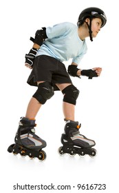 Young skater boy ready to ride on roller skates. He's looking at something. Side view. Isolated on white background.