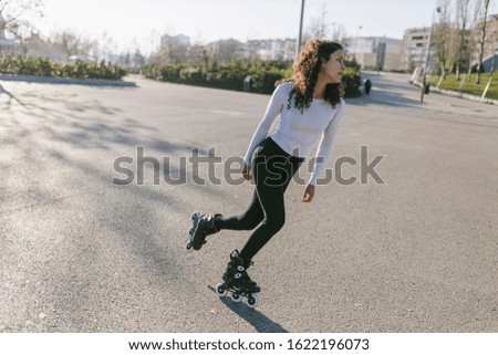 Young skater woman training in a skate park