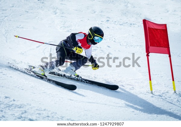 young skier in action in slalom ski competition\
slalom downhill
