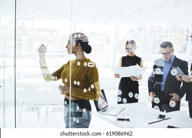 Young skilled afro american elegant dressed female secretary writing on board plan for workshop while professional journalists reading press release of official event in modern conference room - Shutterstock ID 619086962