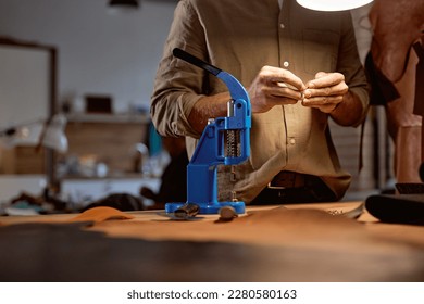 young skilled artisan decorating designing belt at workplace, close up cropped shot, free time, spare time, lifestyle, fashion, decoration - Powered by Shutterstock