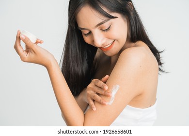 Young Skin Care Asian Woman Applying Body Lotion On Arm And Shoulder