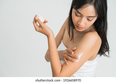 Young Skin Care Asian Woman Applying Body Lotion On Arm And Shoulder