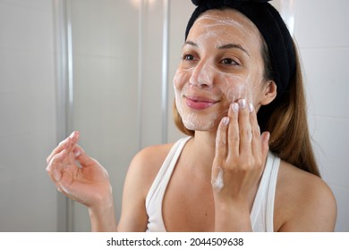 Young Skin Care Routine. Girl Washing Face Foaming Soap Scrubbing Skin. Face Wash Exfoliation Scrub Soap Woman Washing Scrubbing With Skincare Cleansing Product.