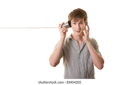 Young skinny Caucasian man with tin can phone over white background