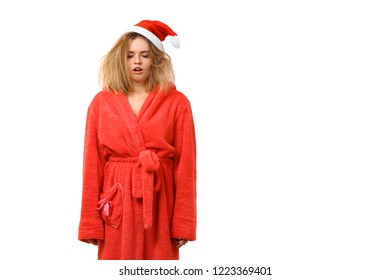 Young Sleepy Girl In A Dressing Gown Wearing Santa Claus Hat Yawns. Wants To Sleep. New Year. Christmas. Isolated On White Background.