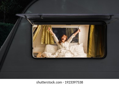 young sleepy woman on bed of a camper RV van motorhome - Powered by Shutterstock