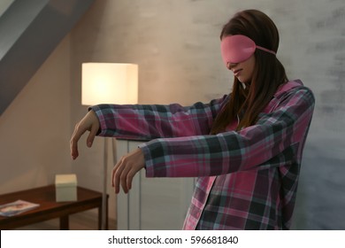 Young Sleepy Woman Suffering From Somnambulism At Home