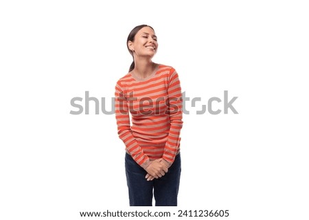 a young slender Caucasian woman with black hair is dressed in a striped tight-fitting orange jacket on a white background