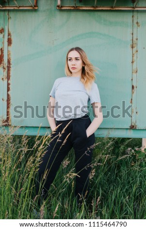 Similar – young girl standing near old building with wires