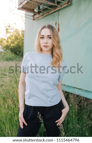 Similar – young girl standing near old building with wires