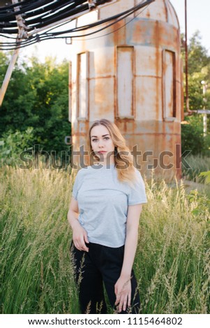 Similar – young girl standing near old building with wires