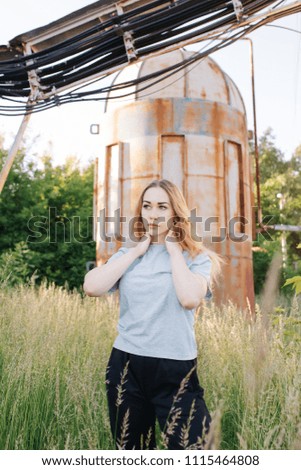 young girl standing near old building with wires